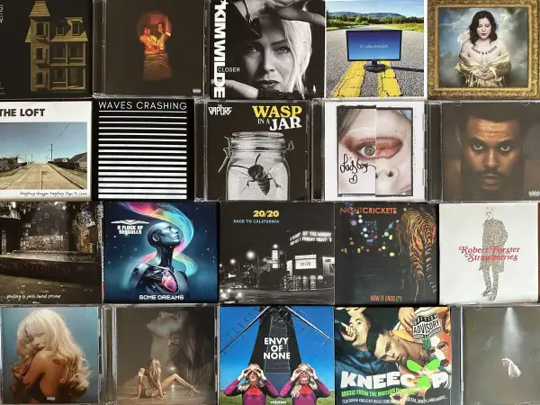 A collage of CD covers, featuring 80s artists like Kim Wilde and A Flock of Seagulls, alongside modern music.