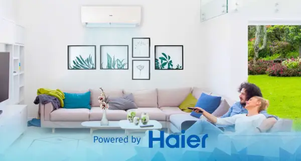 Coppia rilassata sul divano, godendosi la temperatura ideale in casa grazie a Haier.