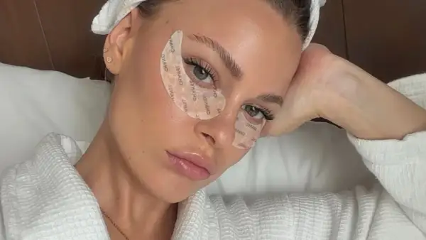 Mujer con parches en los ojos, luciendo relajada. Quizás se pregunta: ¿vitamina k para qué sirve?