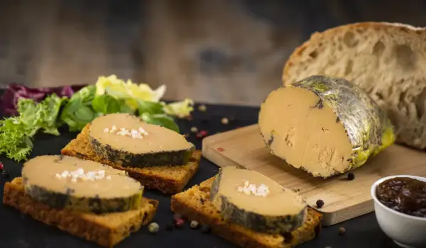 Tranches de foie gras sur toasts, accompagnées de salade verte, pain frais et confiture. La cuisson du foie gras est parfaite.