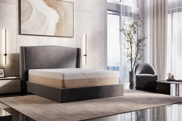 A Saatva memory foam mattress on a bed, showcasing its durability and comfort in a modern bedroom setting.