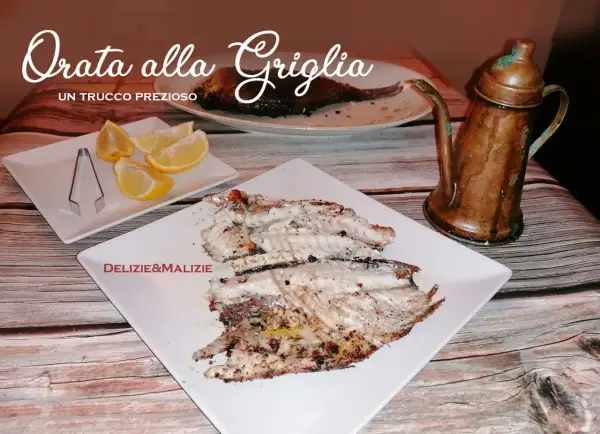 Orata alla griglia succulenta, servita con spicchi di limone e un'antica oliera in rame. Un vero tesoro culinario.