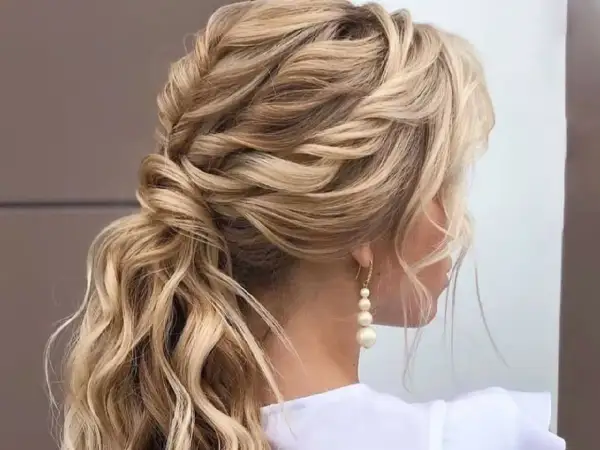 Peinado de novia con trenzas y ondas sueltas, ideal para bodas de ensueño.