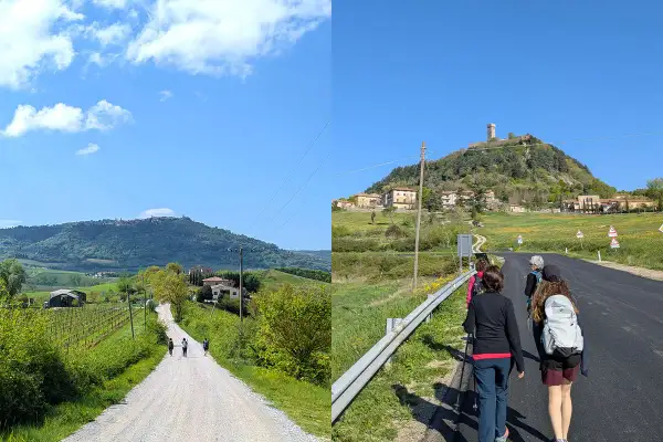 Pellegrini sulla Via Francigena, un cammino che porta verso un borgo arroccato su una collina, evocando il suo antico significato.