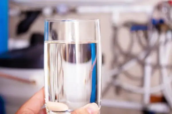 Verre d'eau pure, prêt à boire, issu d'un adoucisseur d'eau, pour une hydratation saine selon l'OMS.