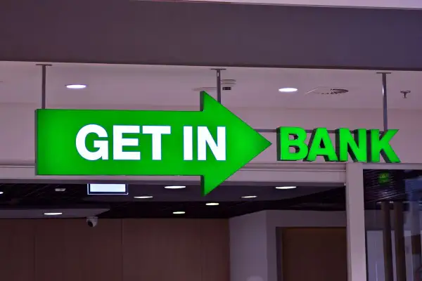Zielona, podświetlana strzałka z napisem "GET IN" prowadzi do wejścia do banku.