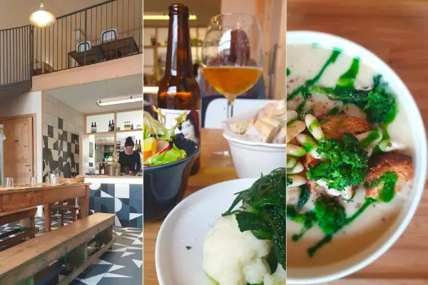 Interno di una trattoria a Rimini centro: tavoli in legno, bancone, insalata, birra e zuppa.