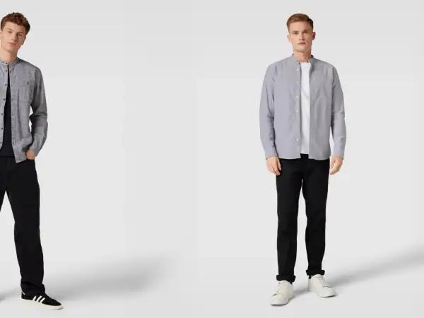 Zwei Männer präsentieren, wie man ein graues Hemd kombinieren kann: lässig mit schwarzer Jeans und Sneakern.