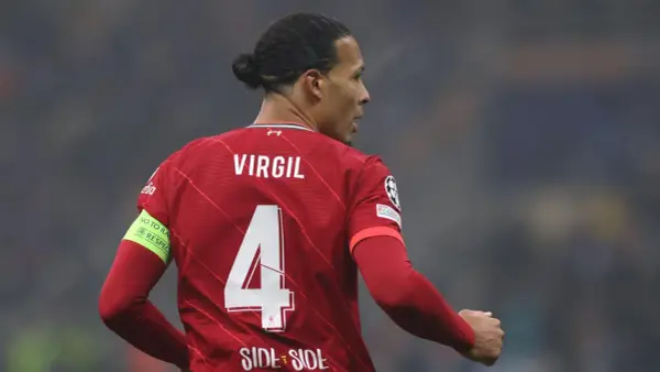 Piłkarz Liverpoolu Virgil van Dijk z numerem 4 na czerwonej koszulce. Na rękawie opaska "No to racism. Respect".