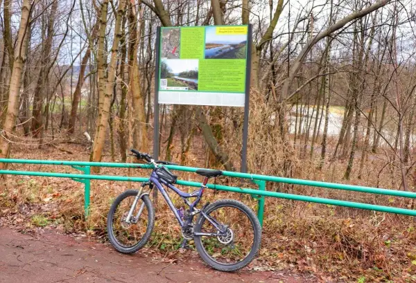 Rower górski przy tablicy informacyjnej o trasie rowerowej Żywiec.