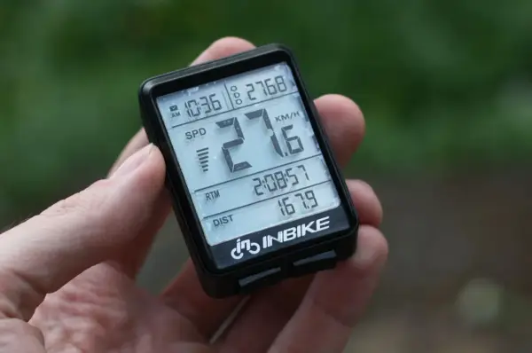 Komputerek rowerowy INBIKE pokazuje 27.6 km/h, 10:36, 2:08:57 i 167.9 km.