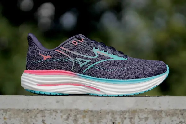 Buty do biegania Mizuno Wave Rider 27 w kolorze fioletowym z różowymi i turkusowymi akcentami. Mizuno to znana japońska marka odzieży sportowej.