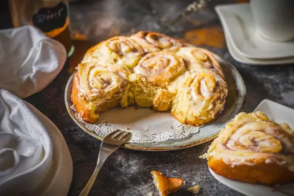 Frisch gebackene Zimtschnecken mit Zuckerguss, ein köstliches Zimtschnecken Rezept, das zum Genießen einlädt.