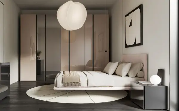 Camera da letto in una casa moderna, con letto rosa, armadio a specchio e lampada a sospensione.