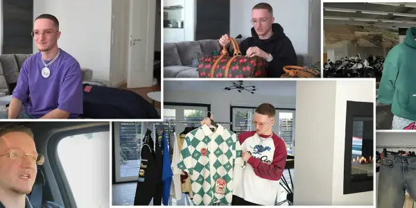 Mann mit Brille präsentiert seine Justin Modemarke Kollektion, darunter Hoodies, Hemden und eine Tasche mit Kirschen.