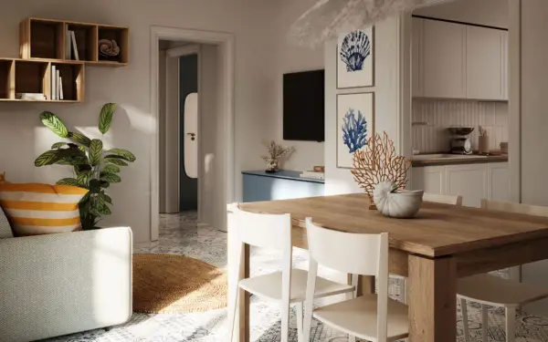 Tavolo in legno con sedie bianche, decorazioni marine e quadri a tema conchiglie: idee originali per arredare casa al mare.