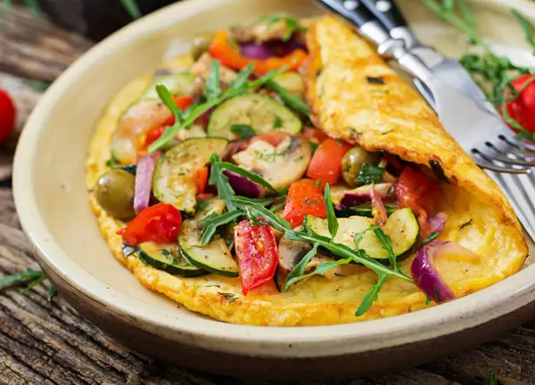 Pyszny omlet dla niemowlaka z cukinią, pomidorkami, oliwkami i rukolą. Zdrowy i kolorowy posiłek.