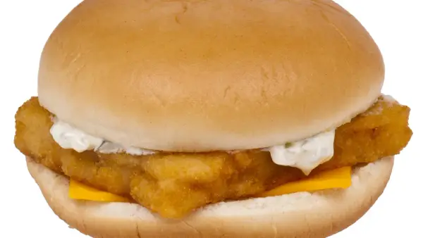 Chrupiący fish mac z serem i sosem tatarskim, zamknięty w miękkiej bułce.
