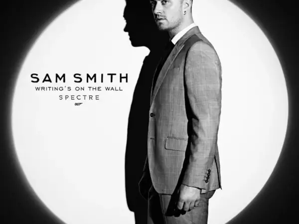 Sam Smith w garniturze, w świetle reflektora, promuje swój utwór "Writing's on the Wall" do filmu o Jamesie Bondzie, Spectre.