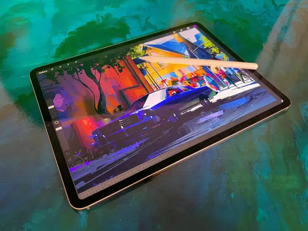 Tablet z rysunkiem ulicy i samochodu, idealny do tworzenia cyfrowych dzieł. Ranking tabletów graficznych podpowie, który wybrać.