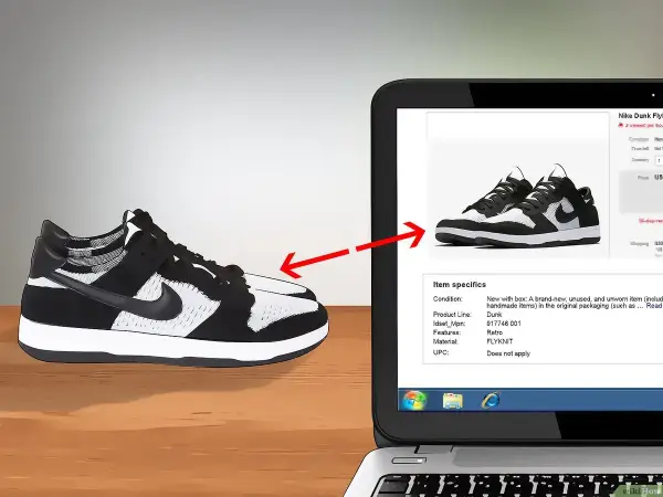 Schwarze und weiße Nike Dunk Flyknit Sneaker werden auf einem Laptop-Bildschirm gezeigt, um das Nike Modell herausfinden.