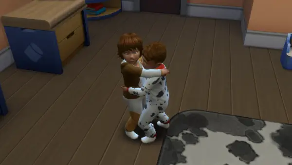 Dzieci w piżamkach przytulają się. W The Sims 4, aby zrobić dziecko, potrzebujesz dorosłych Simów i łóżka.