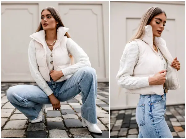 Elegancka stylizacja: jak nosić kamizelkę puchową z jeansami i swetrem. Kremowa kamizelka puchowa, biały sweter z warkoczami, szerokie jeansy i białe botki.