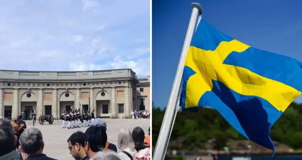 Vaktparad vid slottet i Stockholm på nationaldagen. Svenska flaggan vajar stolt i vinden.