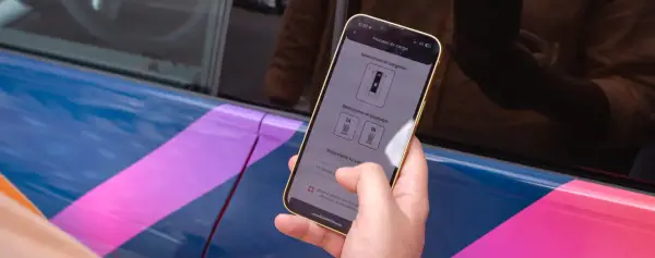 Mano usa el móvil para seleccionar el conector de carga en la mejor app cargadores eléctricos.