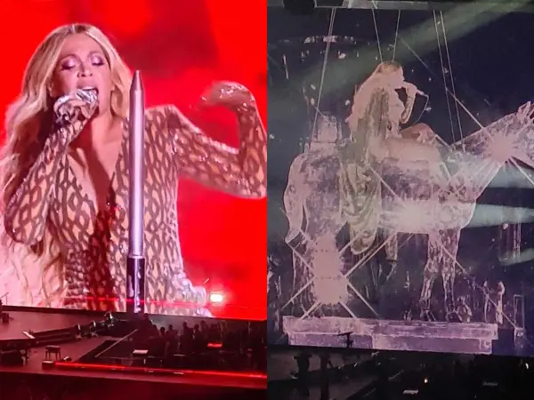 Beyoncé w błyszczącym stroju śpiewa na scenie, a obok niej widać jej sylwetkę na tle scenografii w kształcie konia. Niezapomniany koncert!