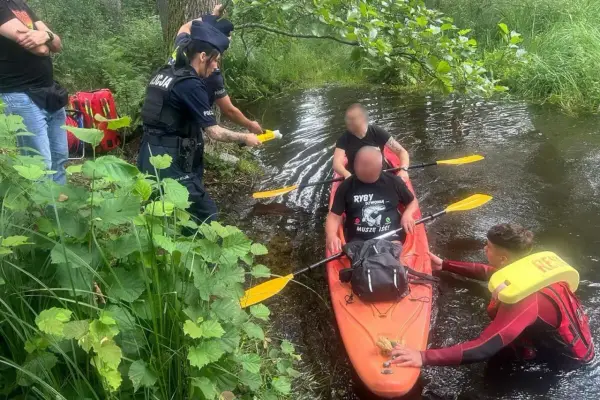 Policja przeprowadza rutynową kontrolę trzeźwości kajakarzy na rzece. Jeden z funkcjonariuszy używa alkomatu.