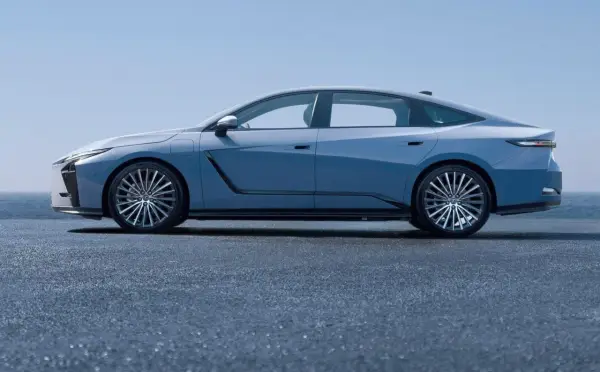 Nowy Lexus ES w błękitnym kolorze, prezentujący swoją elegancką sylwetkę na tle błękitnego nieba i morza.