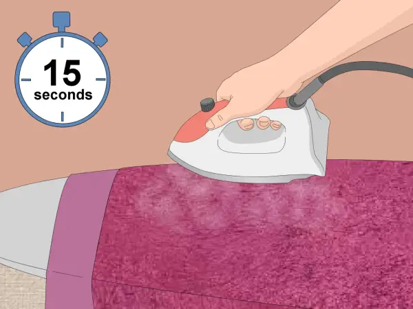 Ironing pink polyester velvet with steam for 15 seconds.