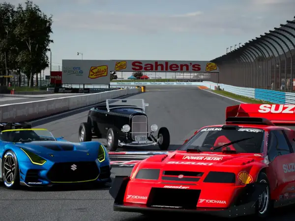 Trzy samochody wyścigowe na torze, w tym niebieski Suzuki, czerwony Suzuki i czarny hot rod. Grafika z gry Gran Turismo na PC.