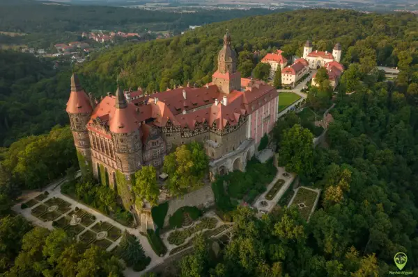 Zamek Książ z lotu ptaka, otoczony lasem. Warto zaplanować cały dzień, by w pełni docenić jego piękno.