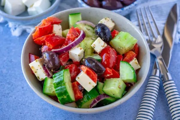 Frischer griechischer Salat mit Tomaten, Gurken, Paprika, roten Zwiebeln, Oliven und Feta – einer der 10 besten Salate für heiße Tage.
