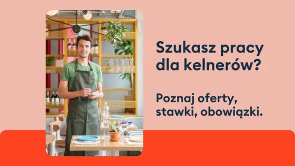 Uśmiechnięty kelner w fartuchu stoi w restauracji, gotowy przyjąć zamówienie. Szukasz pracy dla kelnerów?