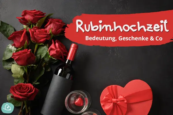 Rote Rosen, Wein und eine Herzschachtel symbolisieren die Rubinhochzeit Bedeutung. Ein Fest der Liebe nach 40 Jahren Ehe.