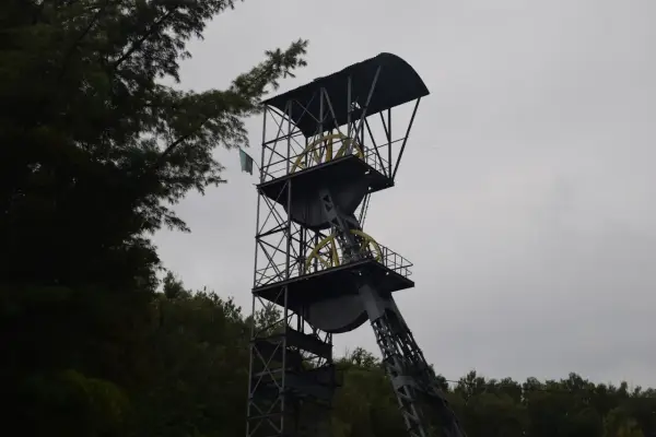 Wieża szybu kopalnianego, jedna z atrakcji Nowej Rudy, z flagą powiewającą na wietrze.