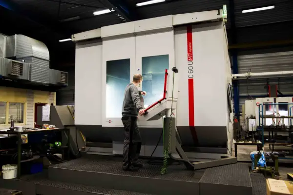 Pracownik obsługuje maszynę CNC w zakładzie w Lelystad.