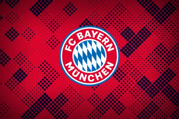 Herb FC Bayern Monachium na tle czerwono-granatowych kropek. Duma Bawarii.