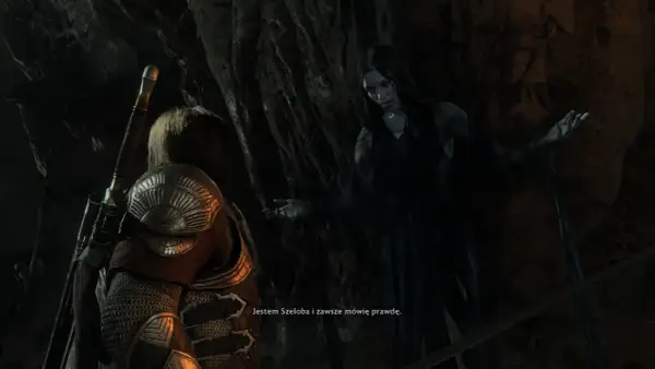 Szeloba, widmowa postać z gry Shadow of War, przemawia do bohatera w mrocznej jaskini.