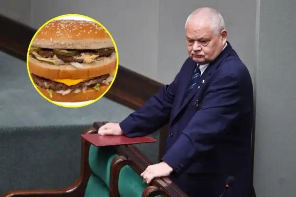 Polityk w garniturze pochyla się nad mównicą, obok widoczny Big Mac. Zastanawia się nad big mac cena?