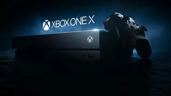 Konsola Xbox One X i kontroler na ciemnym tle. Gotowi na epicką rozgrywkę?