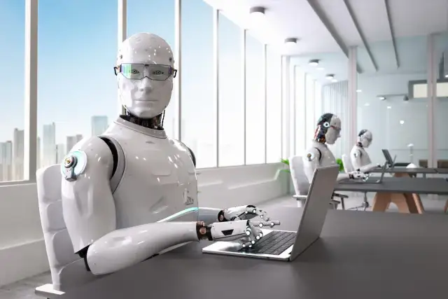 Roboty pracują w biurze, sugerując, jakie zawody zastąpi sztuczna inteligencja.