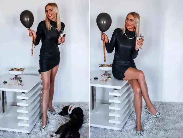 Elegancka czarna sukienka, idealna na 18 urodziny syna. W dłoni balon i kieliszek szampana.
