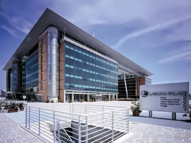 Modern hotel building with glass facade and a sign for Laguna Palace.