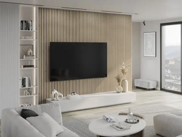 Nowoczesny salon z telewizorem na tle drewnianych lameli i białym regałem.