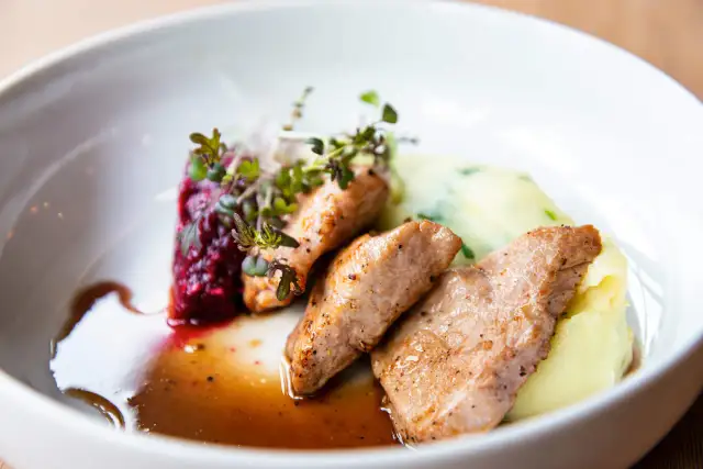 Soczysta polędwica wieprzowa z airfryer, podana z purée ziemniaczanym i buraczkami, udekorowana świeżymi ziołami.