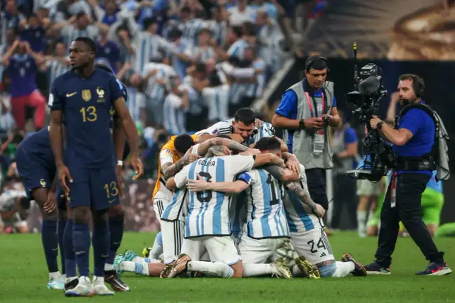 Piłkarze Argentyny świętują zwycięstwo, przytulając się na boisku.